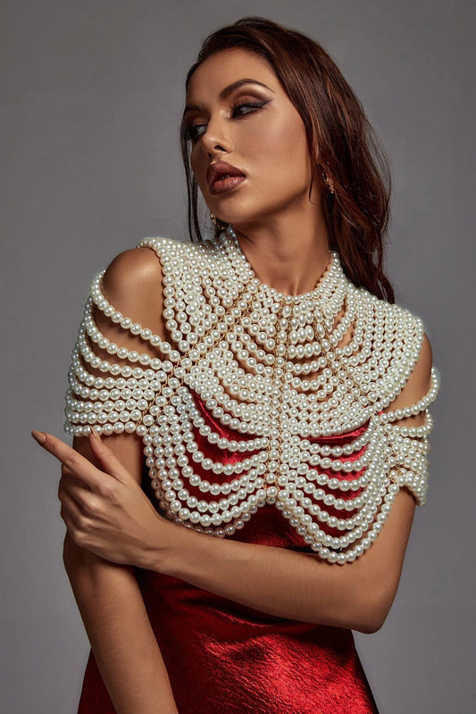 Woman wearing a red dress with a large pearl necklace