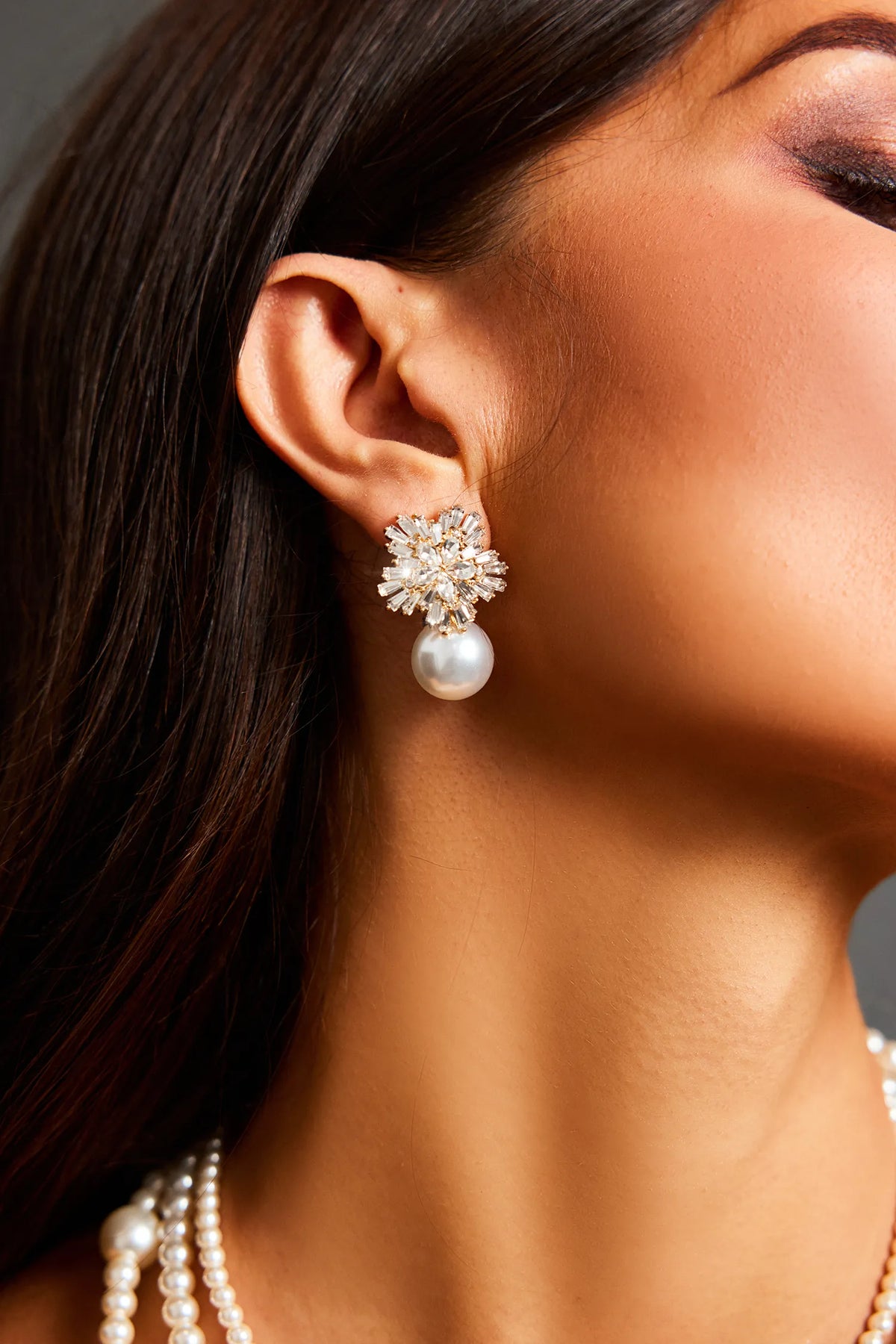 Close-up of a woman wearing a pearl earring 